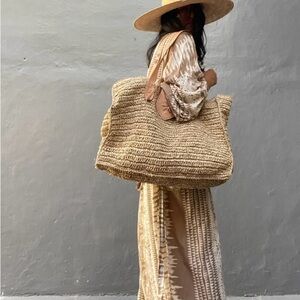 Oversized, woven natural raffia beach bag.